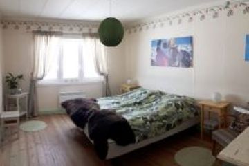 a bedroom with a bed and desk in a room