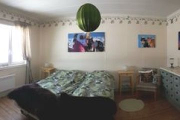 a bedroom with a bed and desk in a room