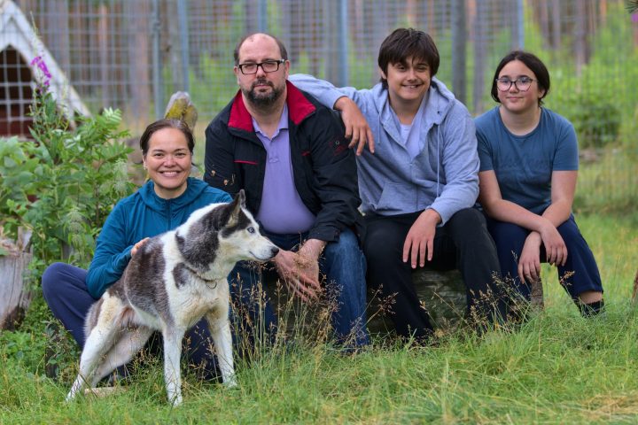 a group of people sitting around a dog