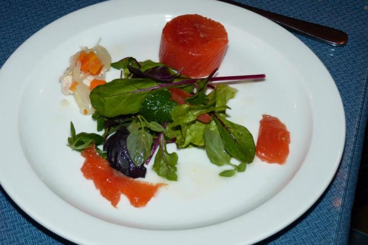 a white plate topped with meat and vegetables