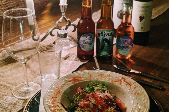 a bottle of wine and a glass of beer on a table